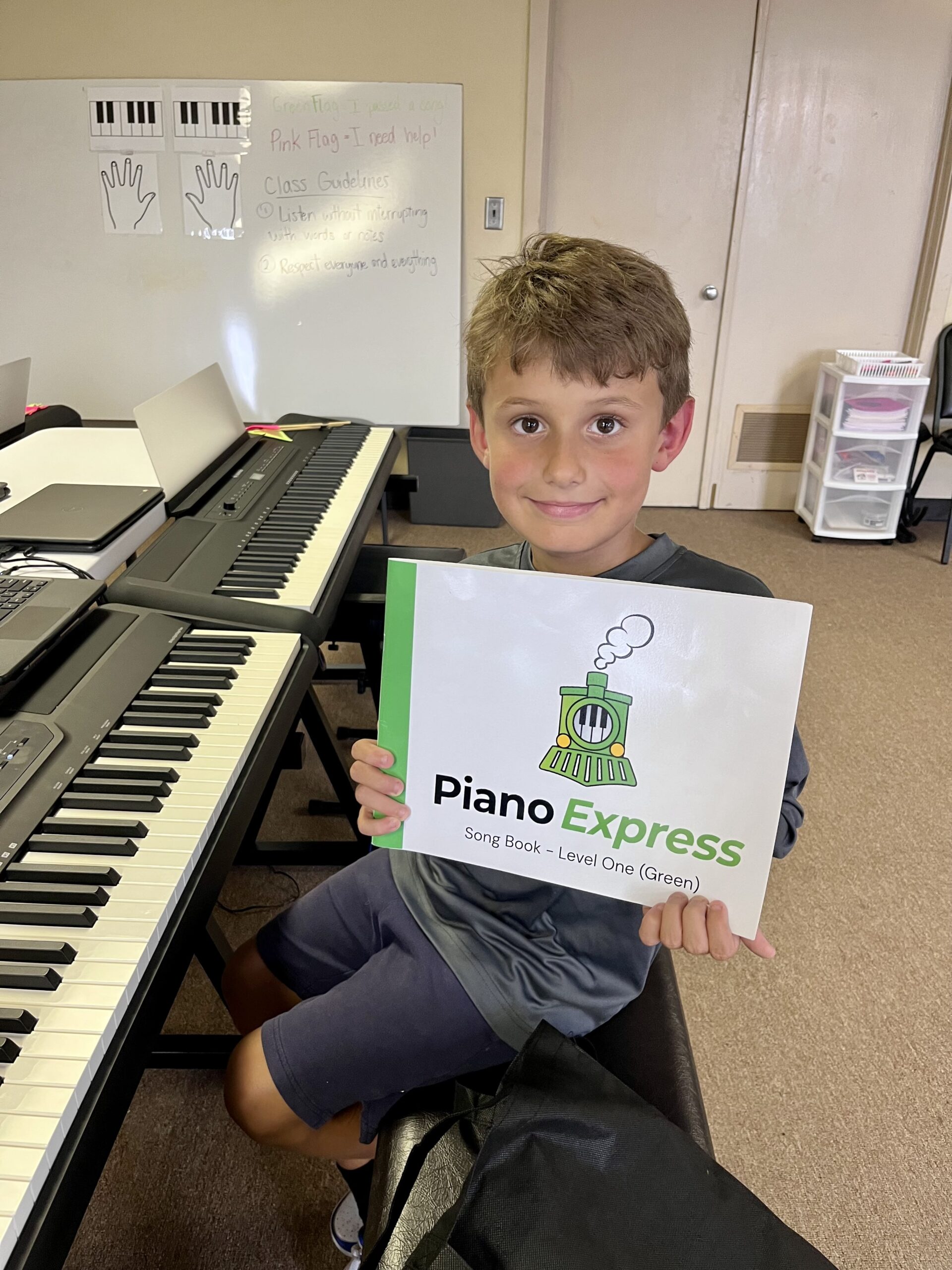 Kids having fun learning piano in a group class