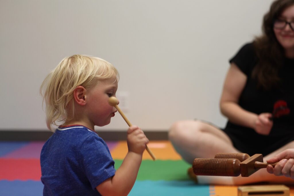 child having fun in mini & me class