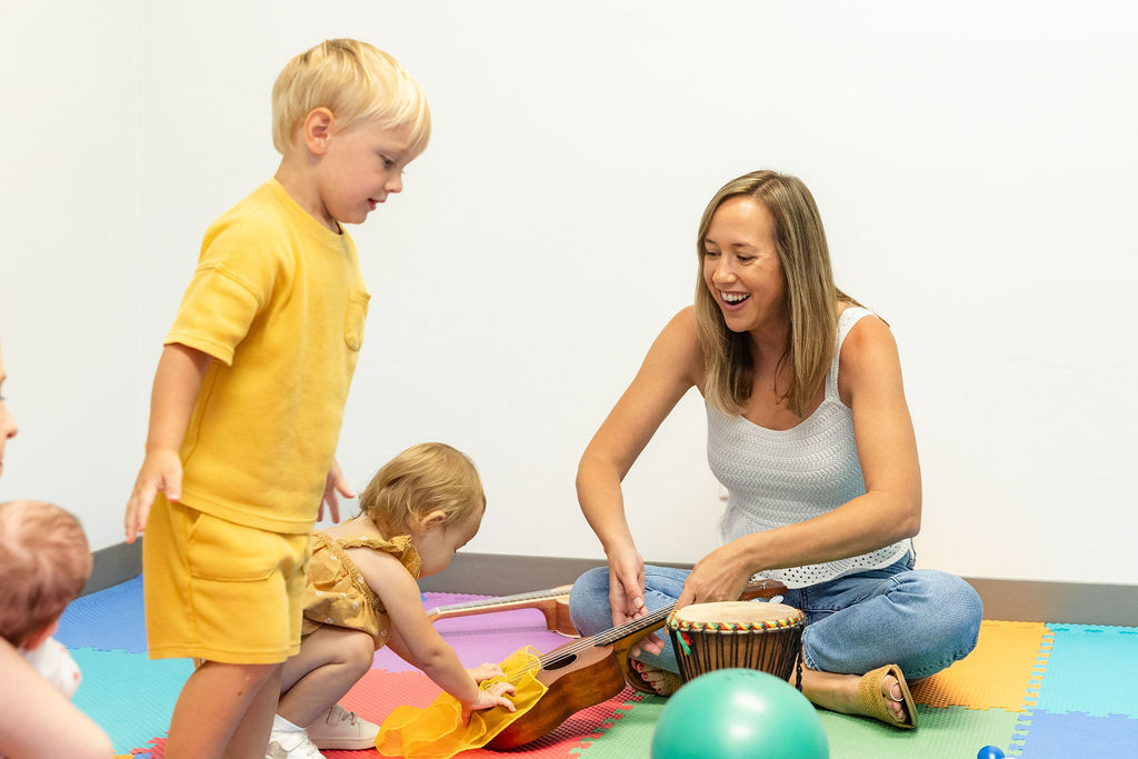 Toddler music class with child and teacher.